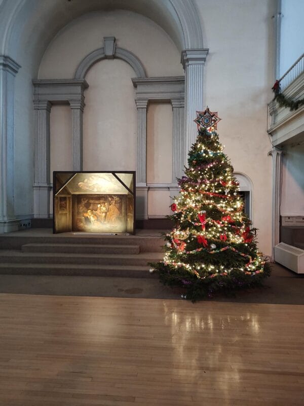 Lit and decorated Christmas tree by Tree Riders NYC at St. Mark's Church in-the-Bowery